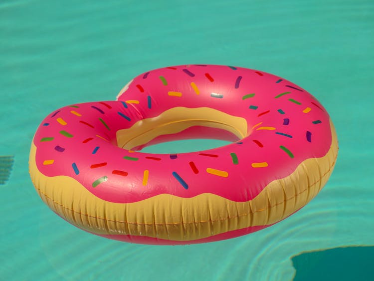 Pink Inflatable Donut Floater On Water