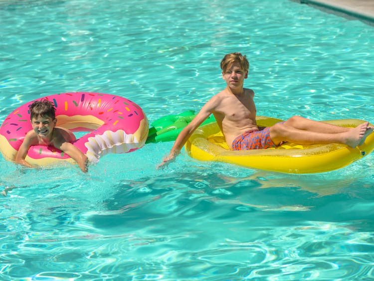 Boys Swimming In The Pool
