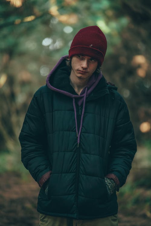 Man Wearing a Green Hoodie Jacket and Red Beanie