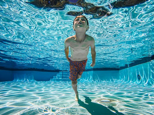 Free Kid Swimming Underwater Stock Photo