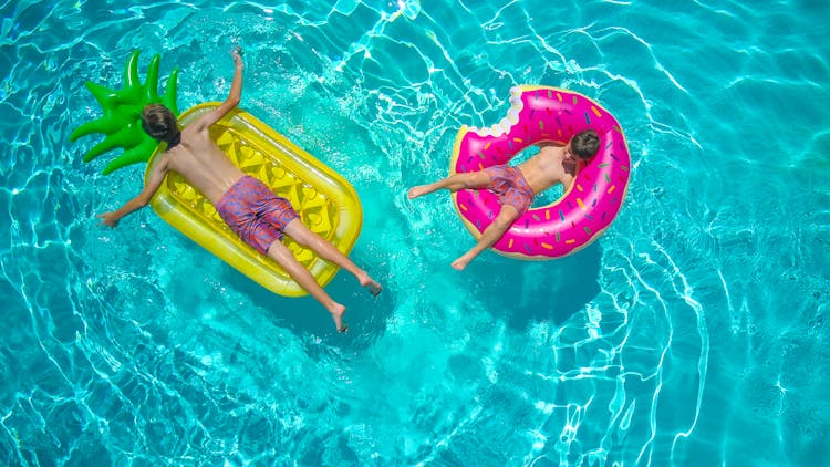 Boys Enjoying On The Swimming Pool