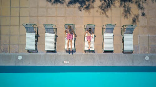 Boys Lying on Pool Chairs