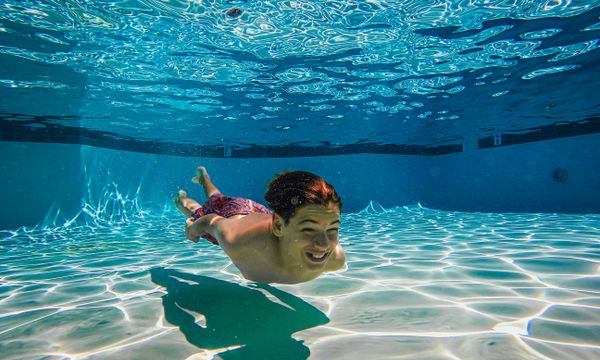 Teenager swimming in pool
