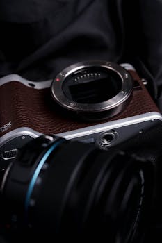 Detailed view of a vintage camera body with leather texture, highlighting classic design.