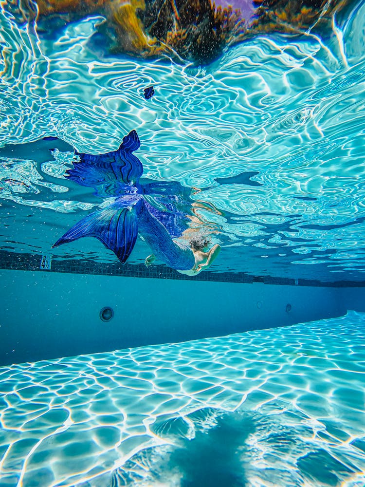 A Mermaid Swimming On A Swimming Pool