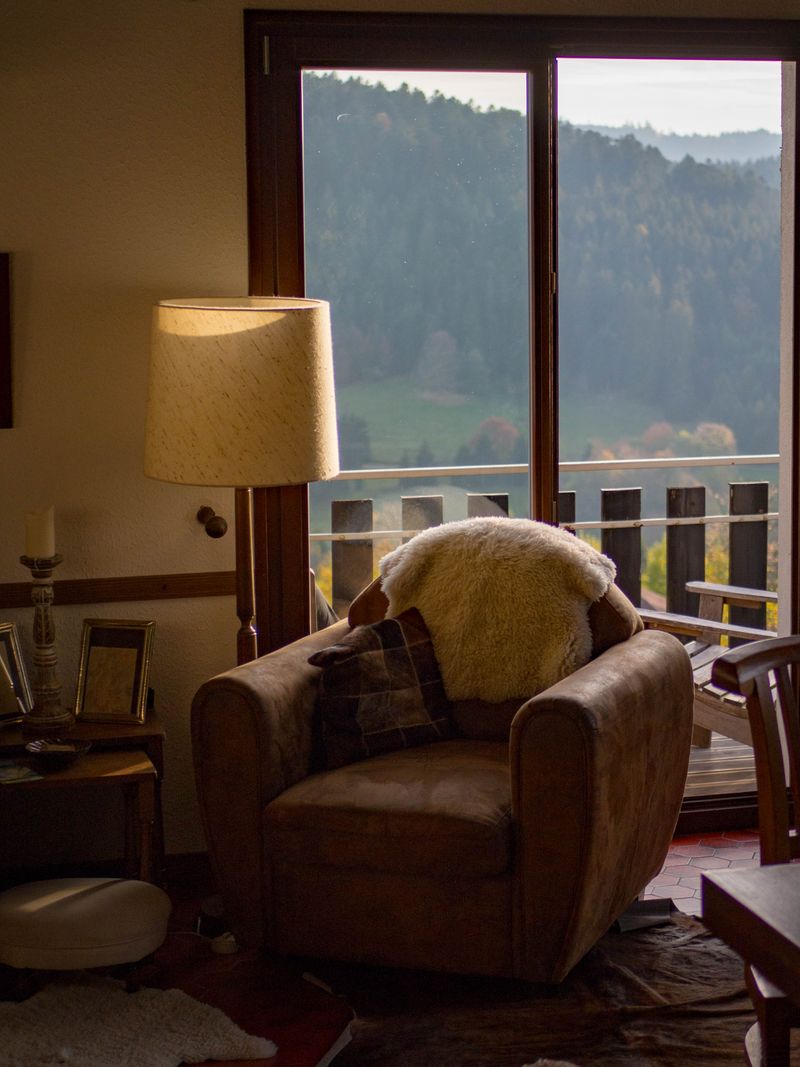 Basho Room seating area near glass door with mountain view