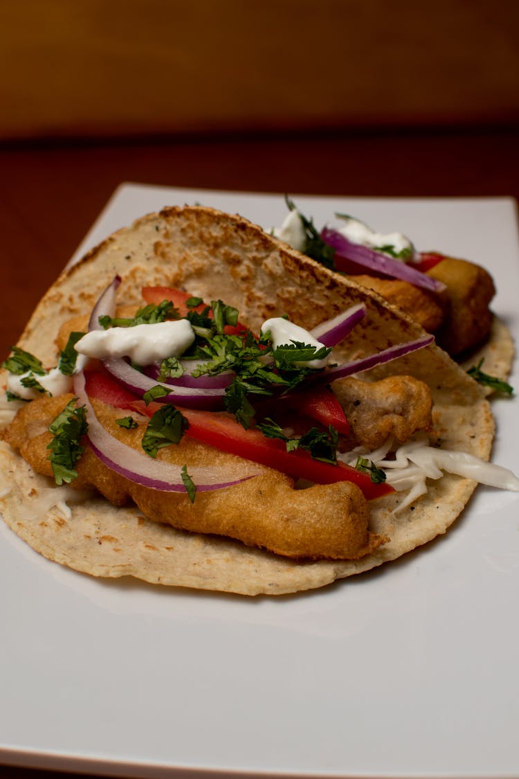 Close-up Of A Tortilla Wrap With Meat, Vegetables And Sauce 