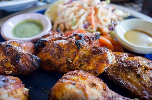 Mouthwatering grilled chicken pieces served with variety of sauces and slaw.