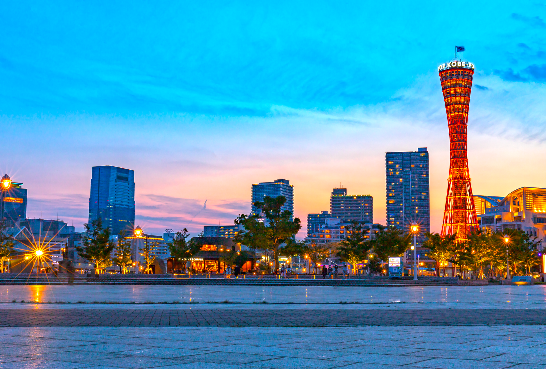 Captivating sunset view of Kobe Port Tower with vibrant cityscape in Japan.