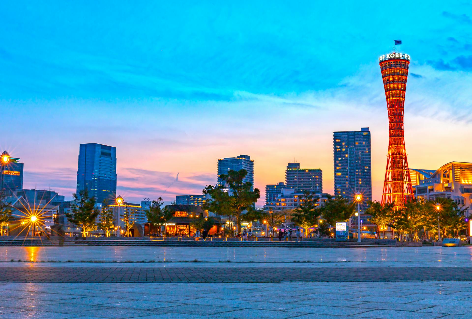Captivating sunset view of Kobe Port Tower with vibrant cityscape in Japan.