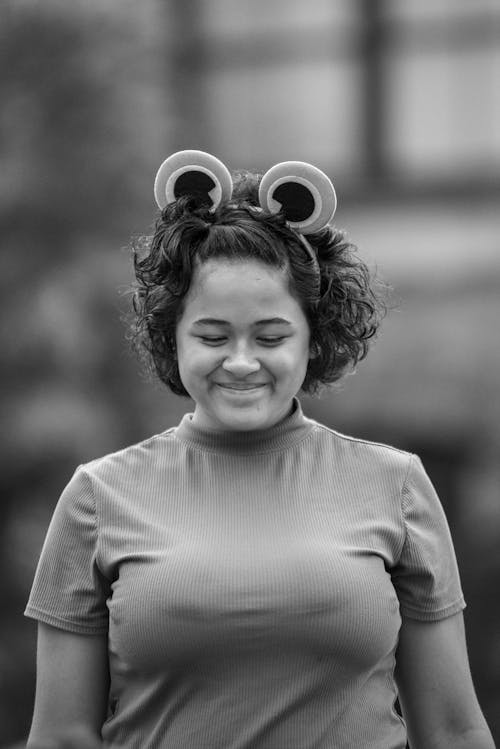 Monochrome Photo of a Woman Smiling while Wearing a Headband