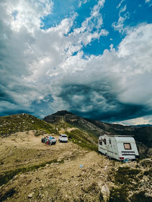 People with Their Vehicles Parked on Mountain Top