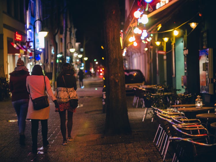 Three Women Walking During Nightime