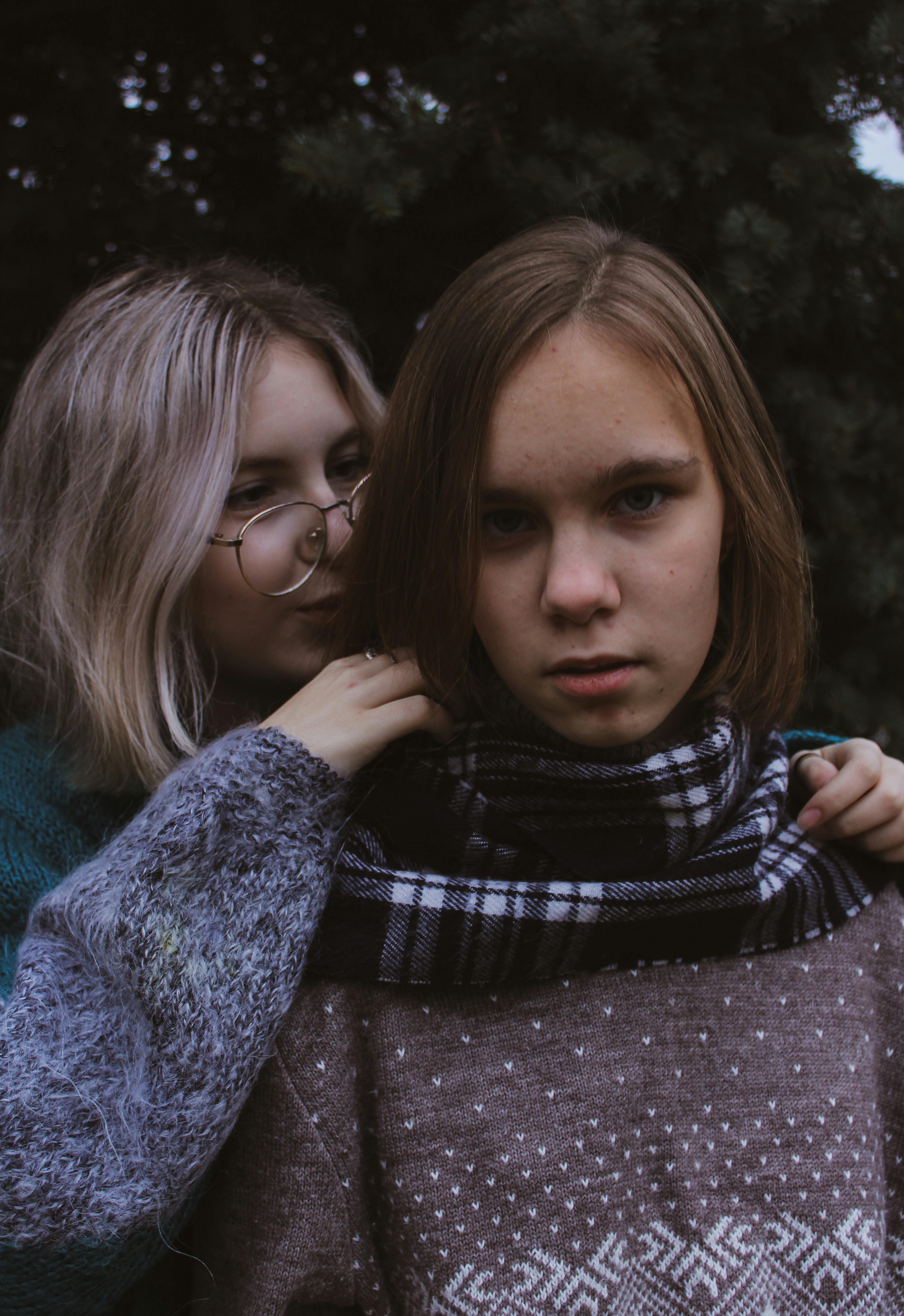 A Two Women Posing Back To Back · Free Stock Photo