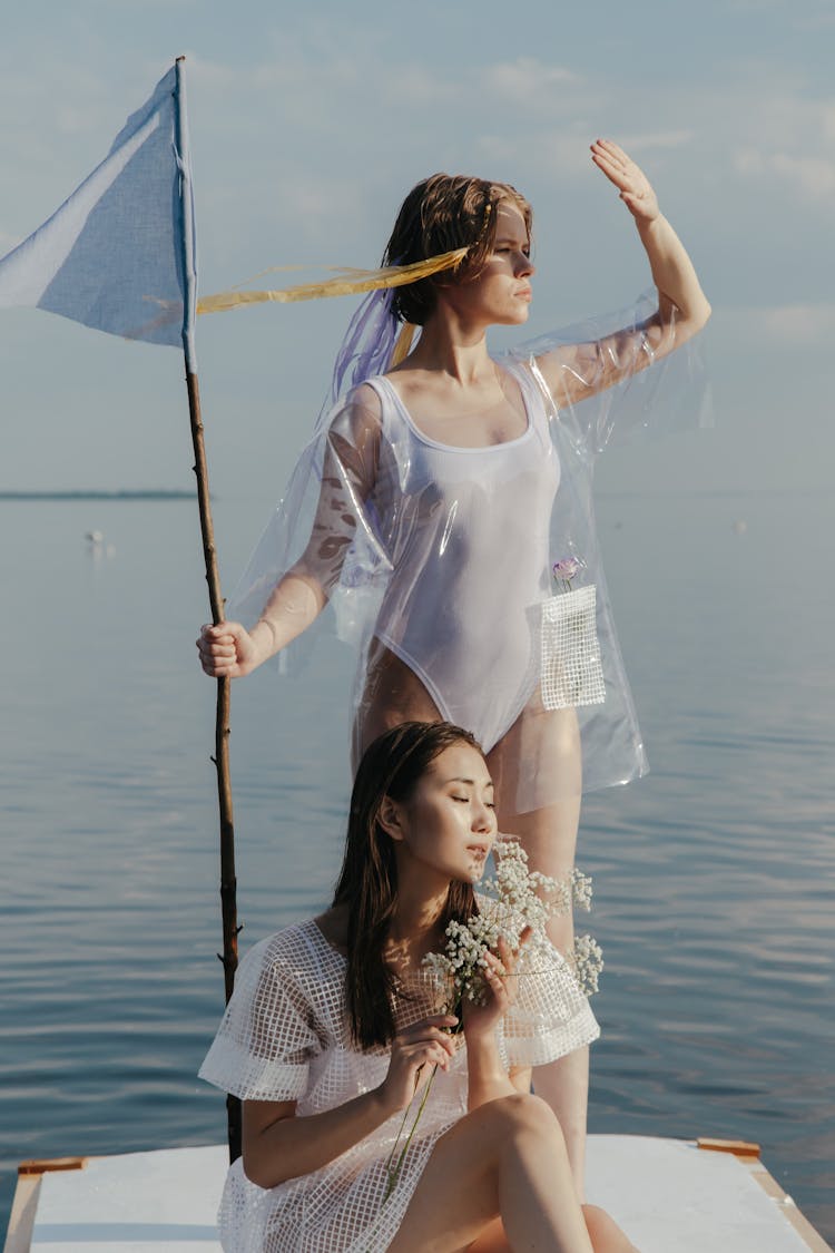 Woman In White Swimsuit Holding A Flag