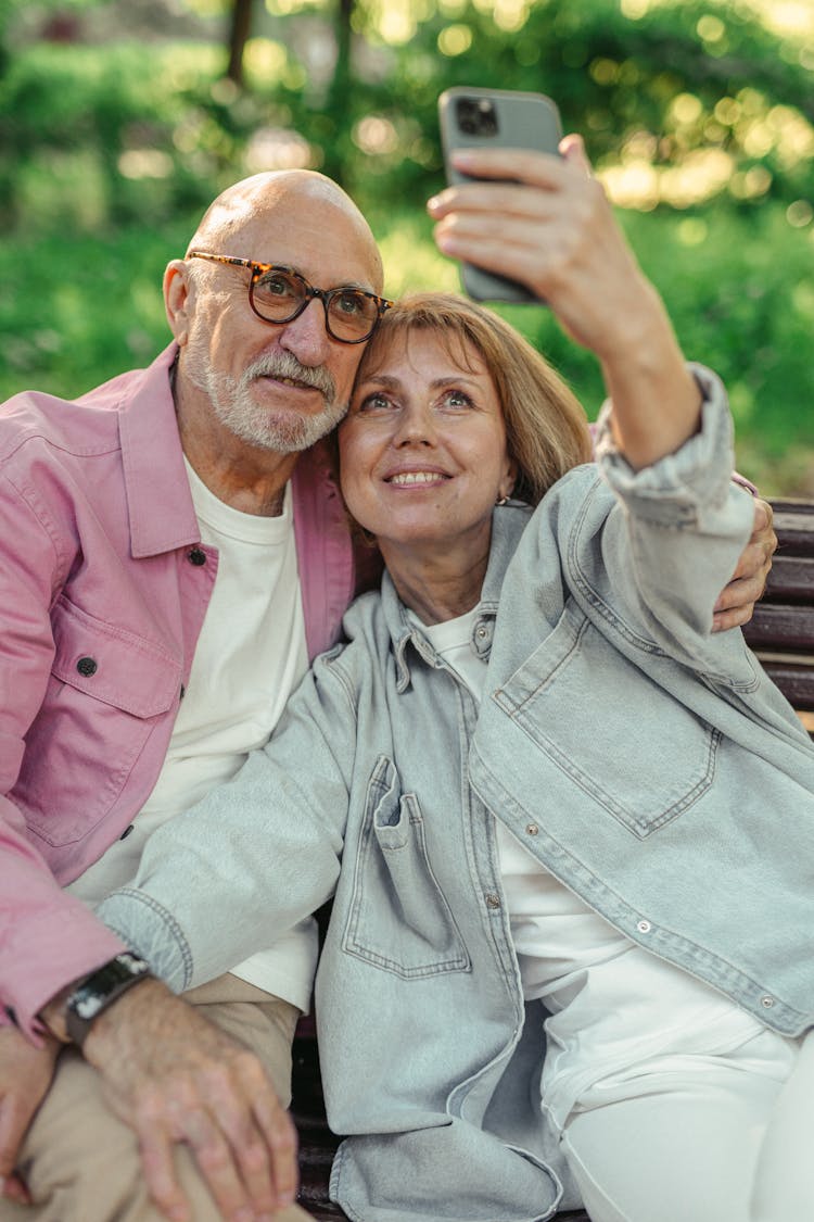 An Elderly Couple Taking A Selfie