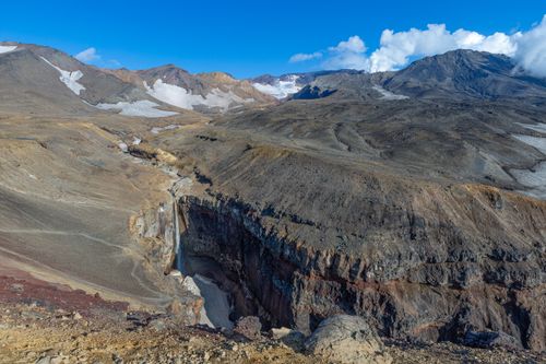 Free Stunning mountain landscape with valleys, rugged terrain, and clear blue skies. Stock Photo