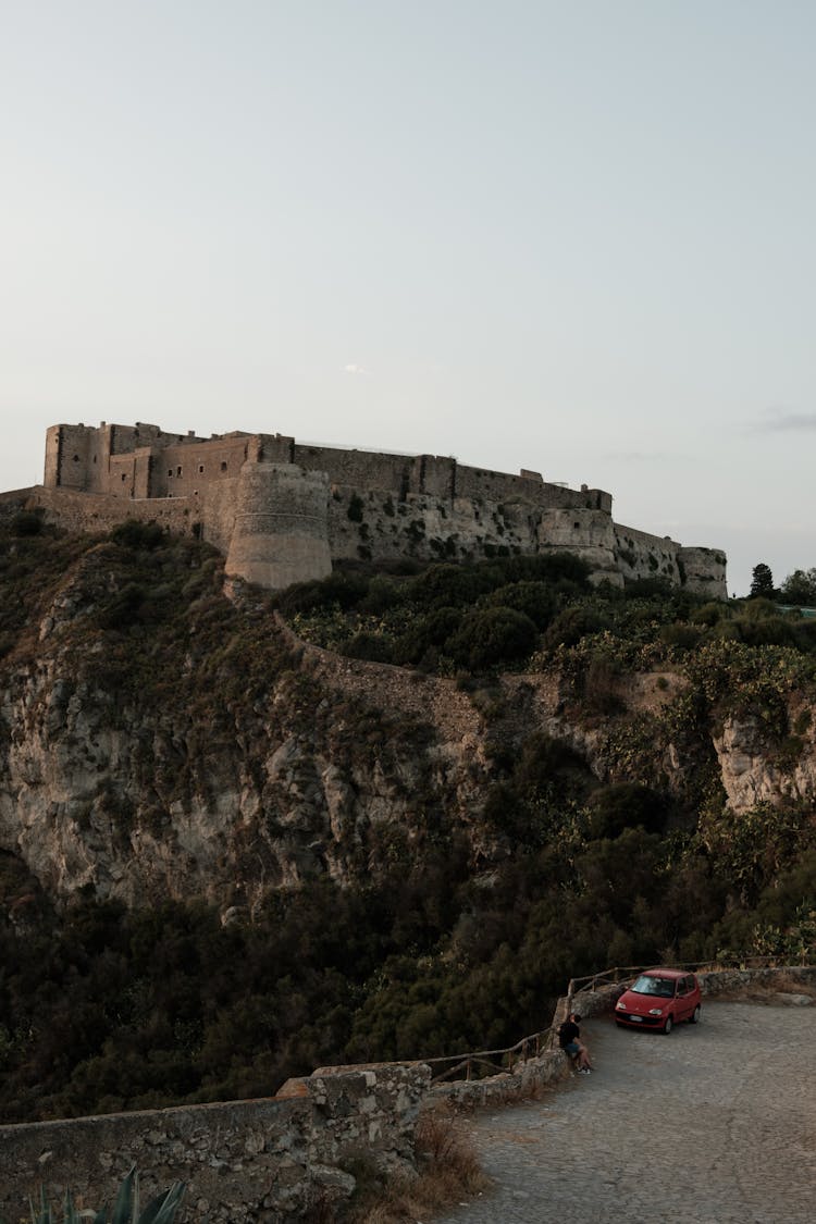 Castle On Hill And Car On Road