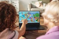 A Person Pointing at a Map on a Laptop