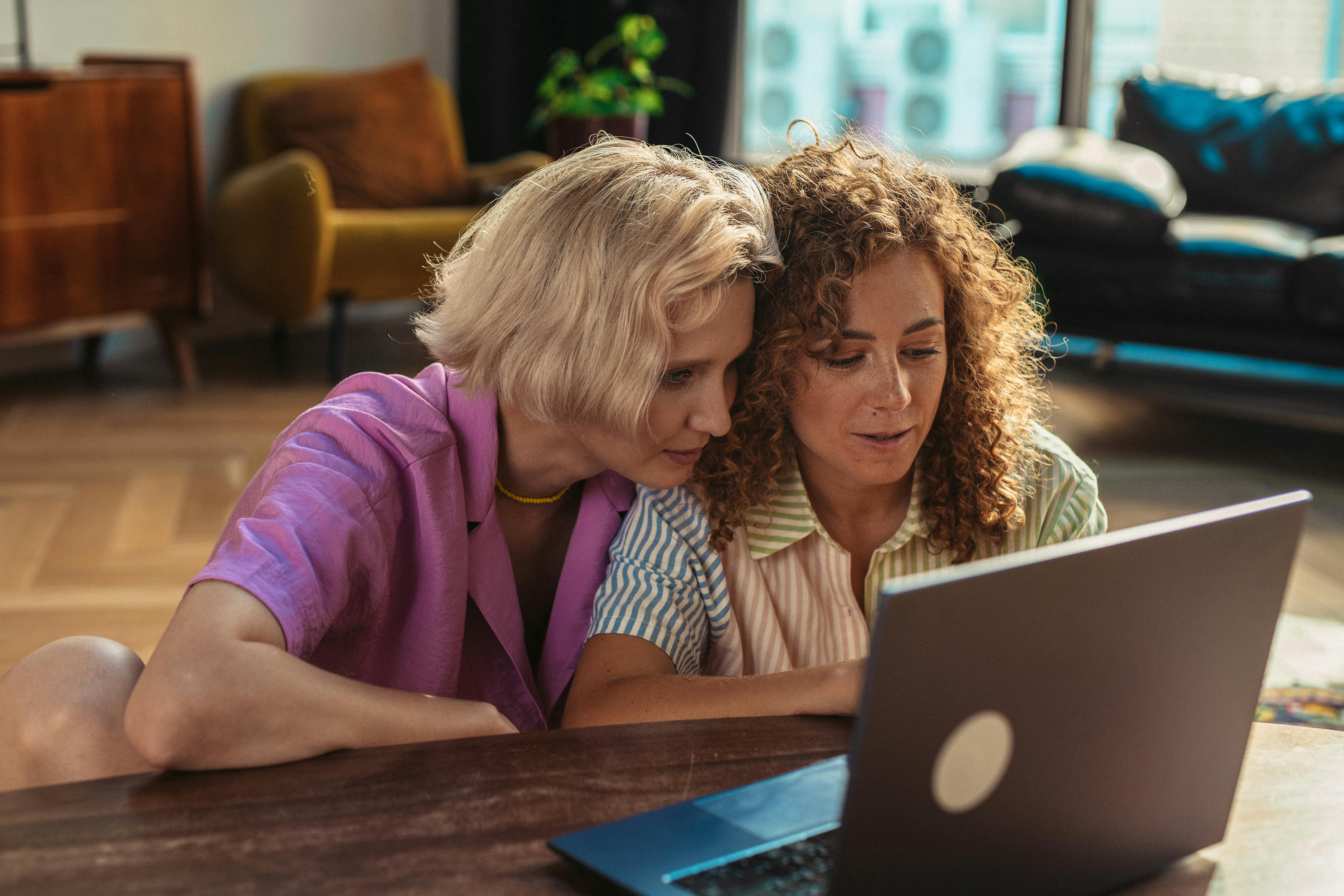 women looking at a laptop together