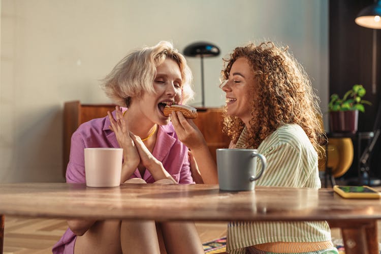 
A Couple Having Coffee And Eating Bread