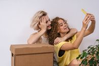 Woman in Yellow Tank Top Hugging Woman in Black and Brown Leopard Print Tank Top