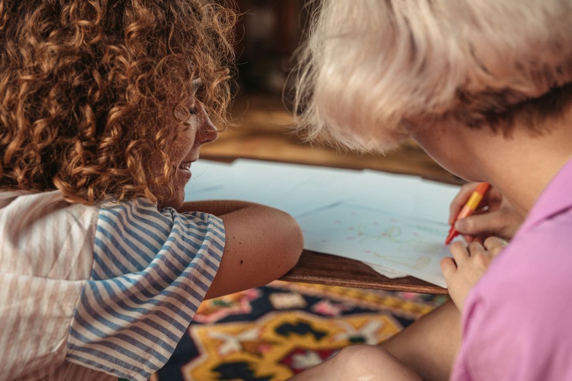 Close-up of Women Sitting at a Table and Drawing · Free Stock Photo