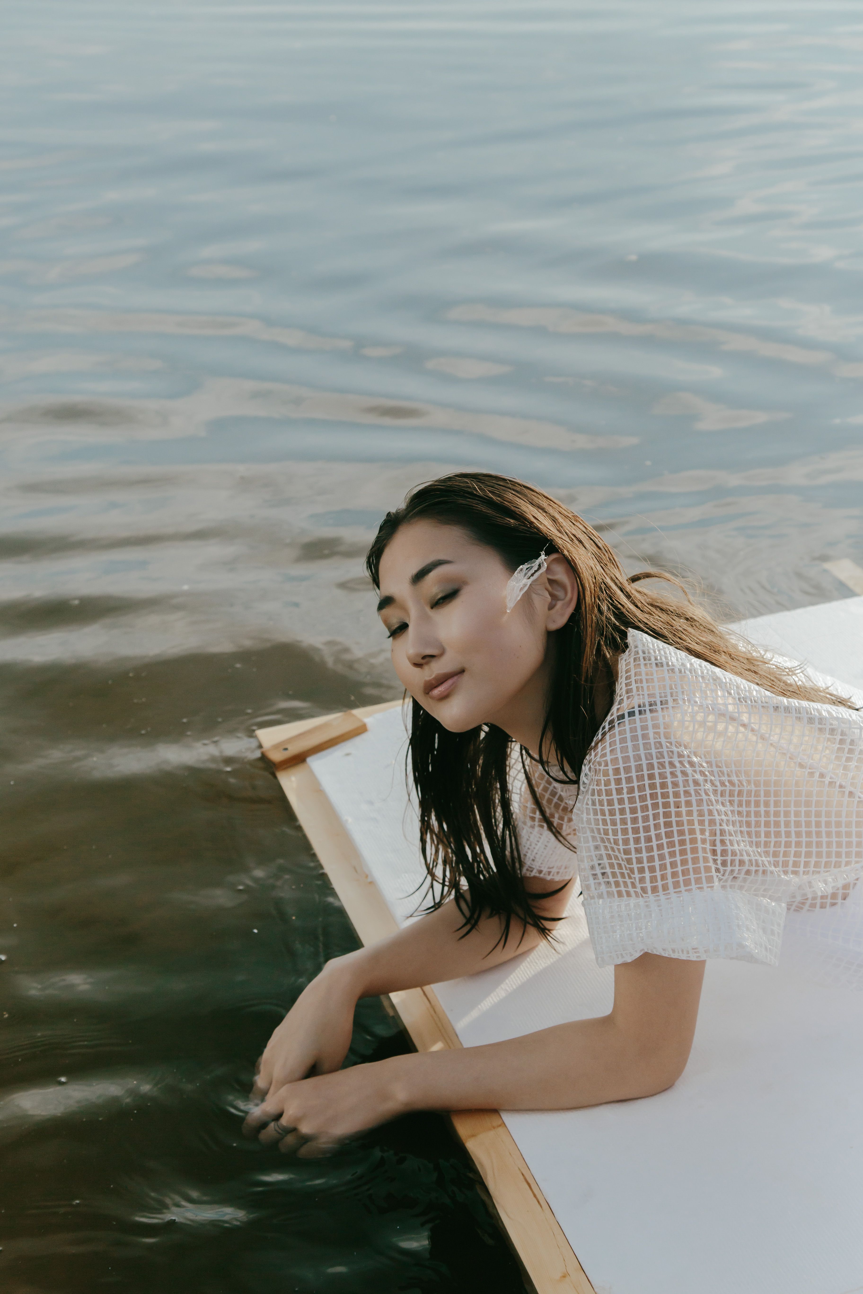 A Woman in White Dress Sitting on the Raft · Free Stock Photo