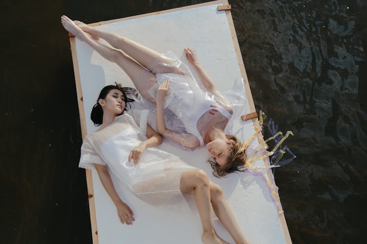 Women Lying On A Raft Floating On Water