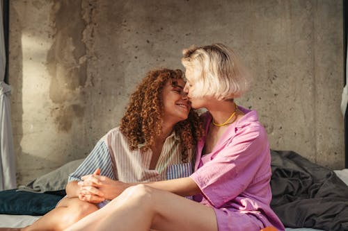 Free A Romantic Couple Embracing on the Bed Stock Photo