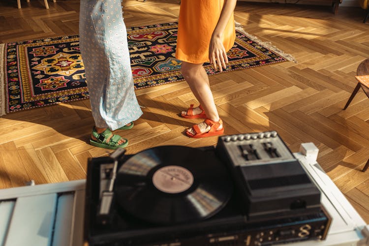 People Wearing Dress And Sandals Standing Near A Turntable