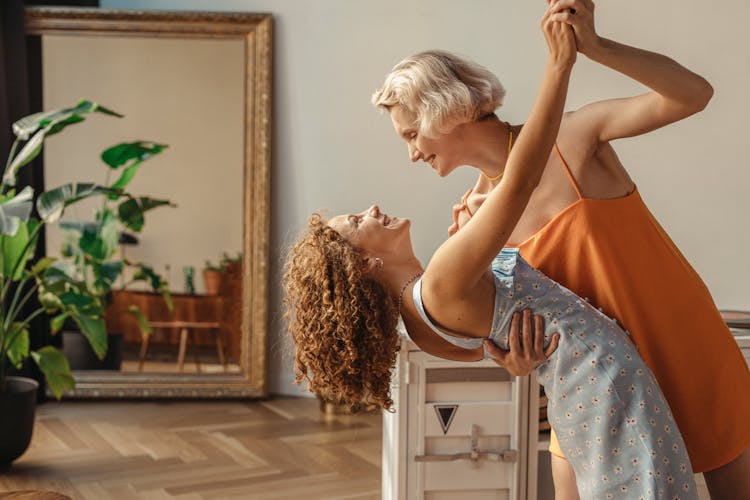 Happy Women Dancing Together Indoors