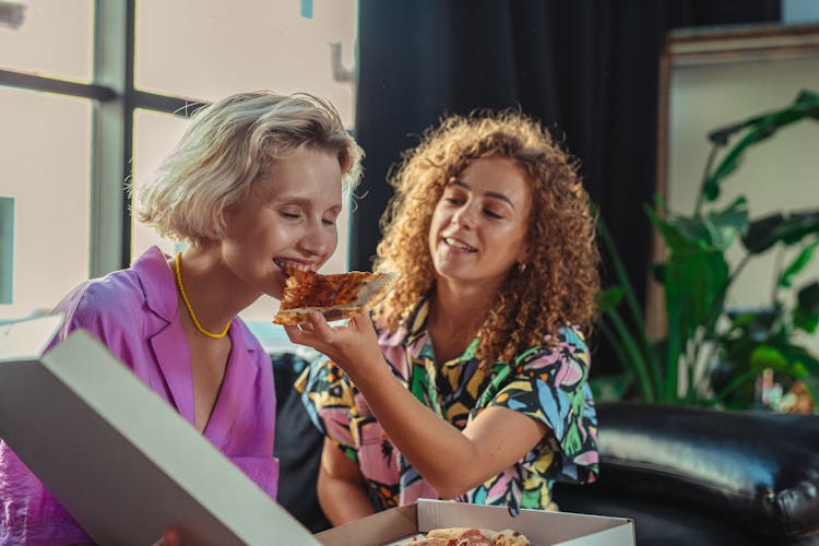 Women Eating Pizza At Home