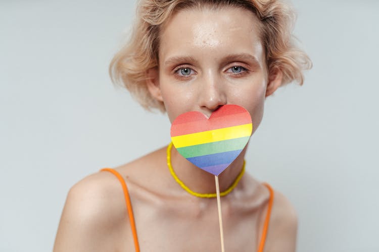 Colorful Heart Shaped Paper On The Woman's Lips 