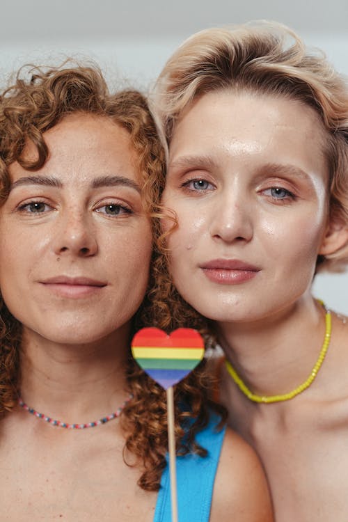 Free 2 Women With Heart Shaped Lollipop on Their Face Stock Photo