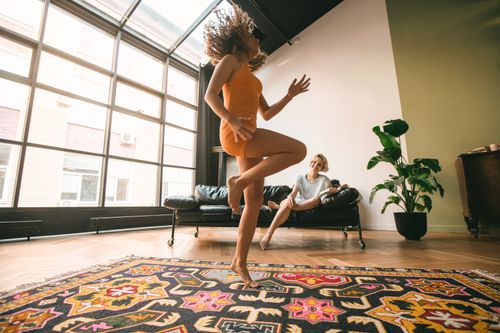 Free A joyful couple enjoying a dance session in a modern living room, highlighting LGBTQ+ relationships. Stock Photo
