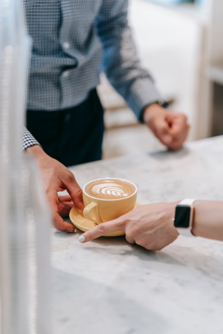 Man Giving Coffee To Woman 