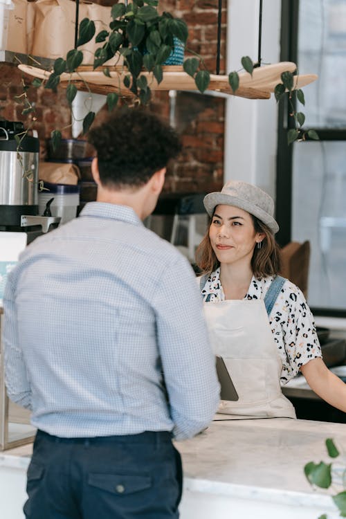 Free Man and Woman Standing at the Counter Stock Photo