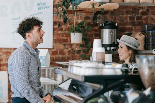 Smiling barista serving a customer at a stylish coffee shop with a rustic interior.