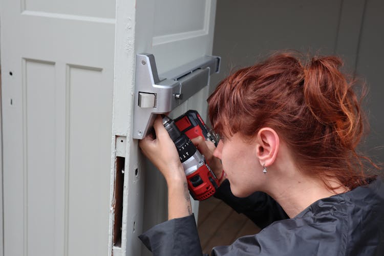 A Woman Using A Drill