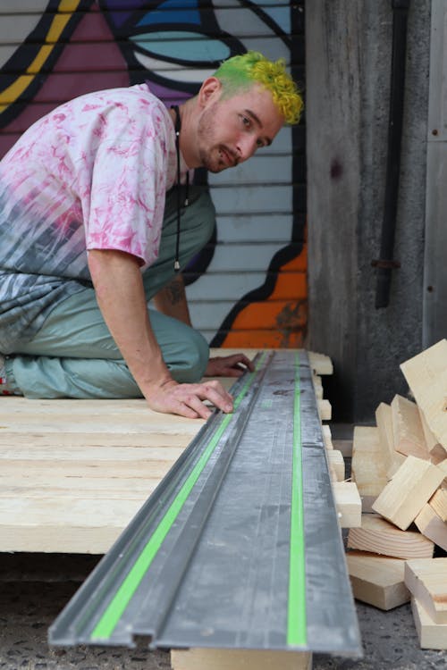 Free A Man Kneeling on the Wood Planks Stock Photo