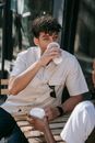 Man in White Button Up Shirt Drinking from White Ceramic Mug