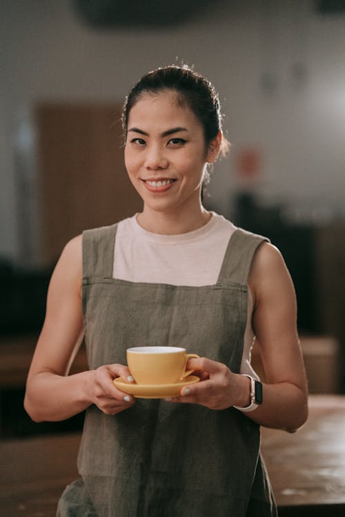 Free Smiling Woman Holding a Cup of Coffee Stock Photo