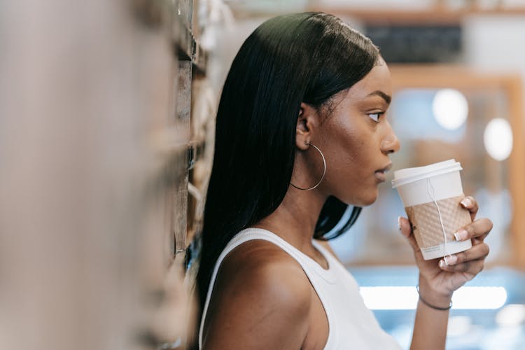 Beautiful Woman Drinking Coffee On City Street