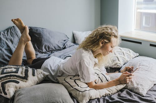 Free A Woman Lying on the Bed Stock Photo