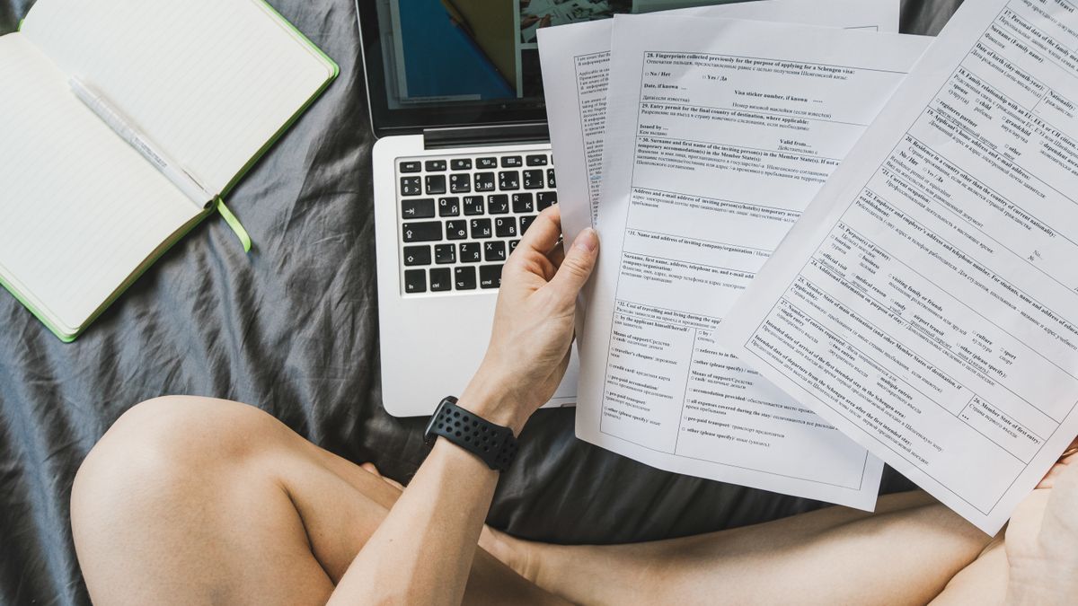 Student completing a college application form at a desk