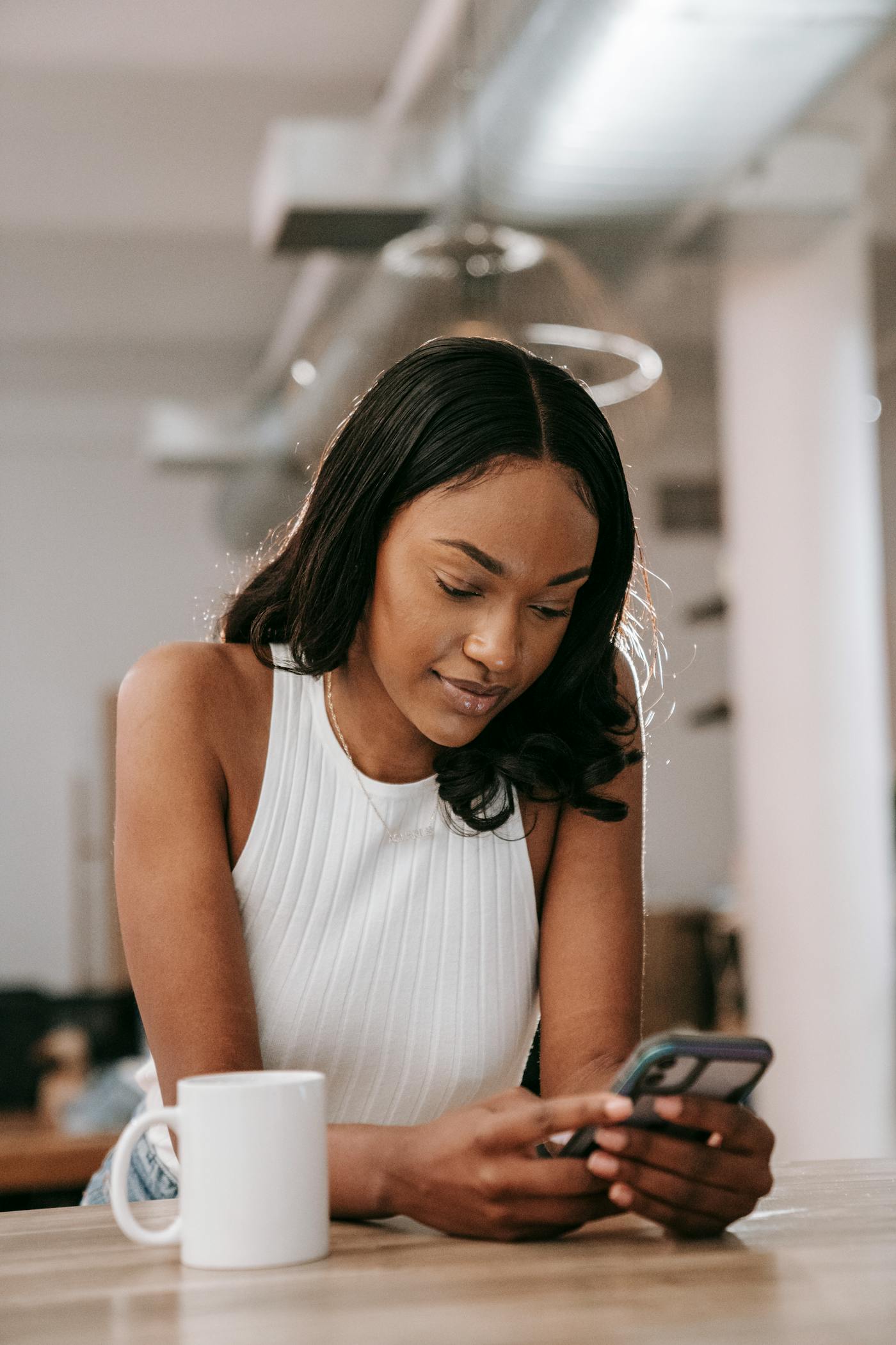Woman using a phone comfortably at home