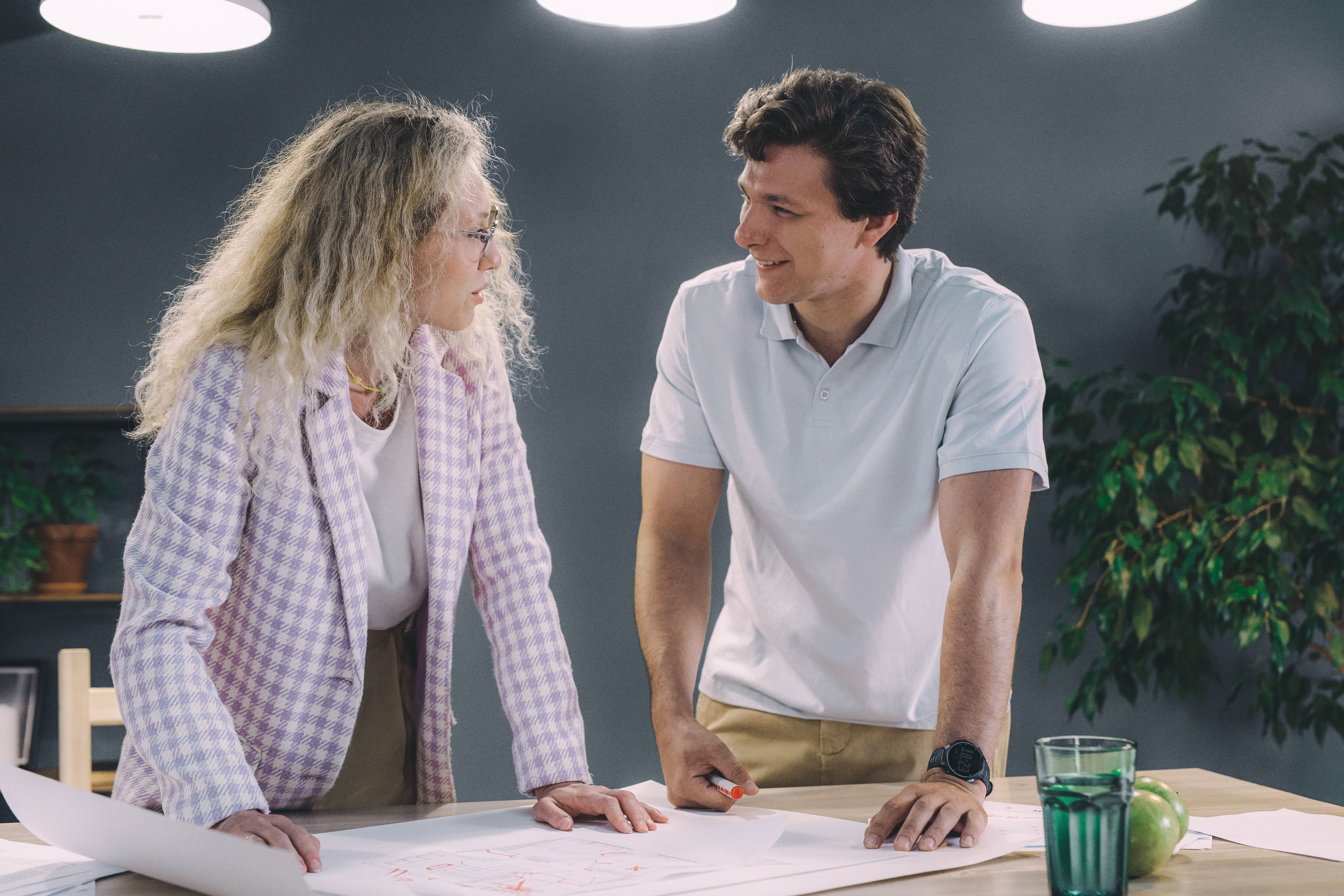 A professional designer collaborating with a team in a modern office