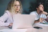 Two colleagues planning at a desk — photo by SHVETS production on Pexels