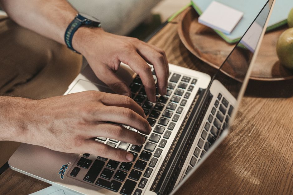 How Apple Watch Fall Detection Supports Elderly Parents Living Alone Close-up of hands typing on a laptop, capturing a productive indoor workspace vibe.